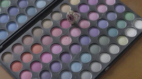 4K S-Log 2 ring on eye make up pallet put on caucasian hand Stock Footage 56527119