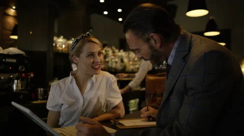 4K Salesman with laptop computer discussing a deal with bar owner 库存影片 64915866