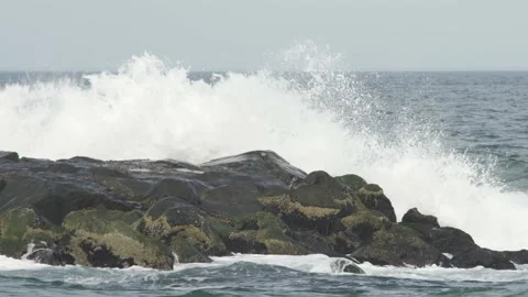 4K. Sandy coast. A big, foaming wave beating against the shore. Stock Footage 130712382