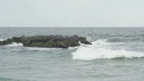 4K. Sandy coast. A big, foaming wave beating against the shore. Stock Footage 130712419