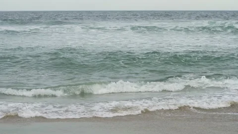 4K. Sandy coast. A big, foaming wave beating against the shore. Stock Footage 130712517