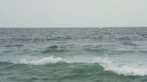 4K. Sandy coast. A big, foaming wave beating against the shore. Stock Footage 130712571