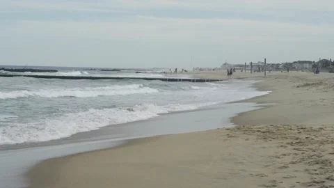 4K. Sandy coast. A big, foaming wave beating against the shore. Stock Footage 130712609