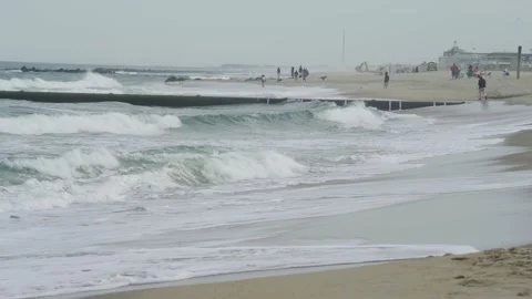 4K. Sandy coast. A big, foaming wave beating against the shore. Stock Footage 130712661