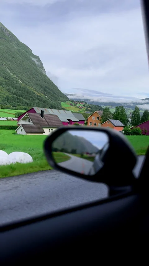 4K Scenic View from Car Mirror, Surrounded by Lush Valleys and Mountains, Norway Stock Footage 296010697