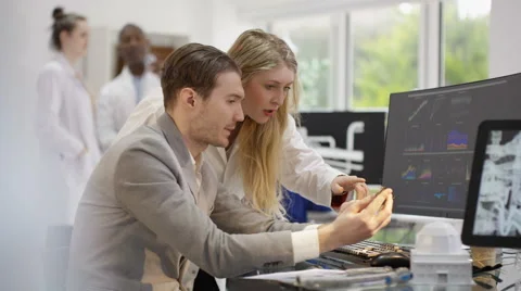 4K Scientific research engineers analyzing technical data with computer software Stock Footage 63300491