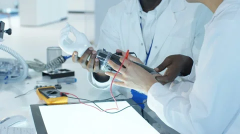 4K Scientific research engineers collaborating on project to build robotic hand Stock Footage 67732683