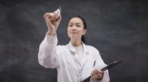 4K Scientist in white coat writing math formula on glass screen in front of came Stock Footage 59730011