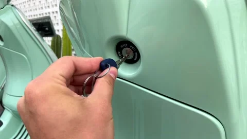 4K. Scooter. Key. Insert key. Green. Bali. Engage. Engine. Arm. Scooter Key. Stock Footage 223548847