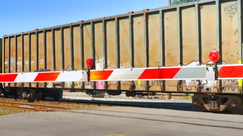 4K Seamless Looping Shot of Train Passing, Flashing Train Crossing Barrier Video stock 65566801