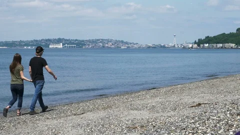 4K Seattle Space Needle Couple Walks Shoreline Together Away From Camera Stock Footage 109034681