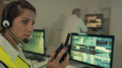4K Security team watching CCTV video screens in observation control room Stock Footage 67752925