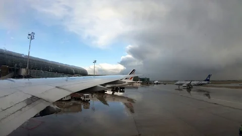 4K Seen through a plane window of airplane arrived to the airport. Rainy day-Dan Stock Footage 107770777