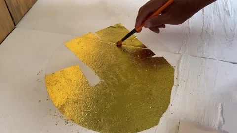 4K Selective Focus: Applying Gold Leaf to Canvas Wall Art Video stock 335010344