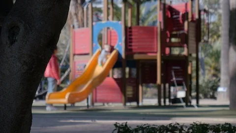 4k selective focus static shot of mother and her small child in a playground Stock Footage 123476594