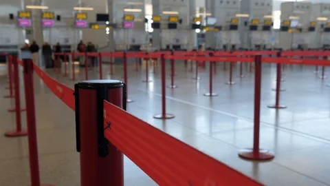 4k selective focus static shot of red tape with empty airport check in desks Stock Footage 123831950