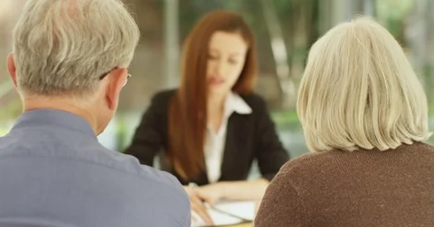 4K Senior couple with financial problems in a serious meeting with bank manager Stock Footage