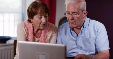 4k, A senior couple using a laptop at home. Stock Footage 67210483