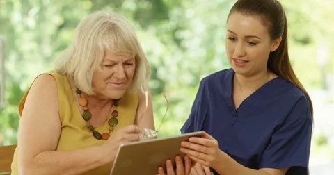 4K Senior lady struggling to learn computer skills, with young nurse helping 動画素材 83045965