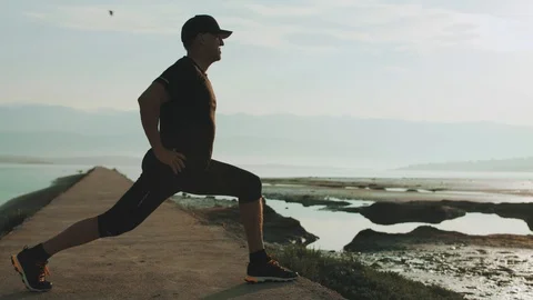 4K Senior Man Doing Stretching Exercises On The Beach In The Summer Stock Footage 93071980
