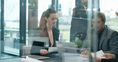 4K Serious business manager looking at camera, surrounded by staff in a meeting Stock Footage 118723772
