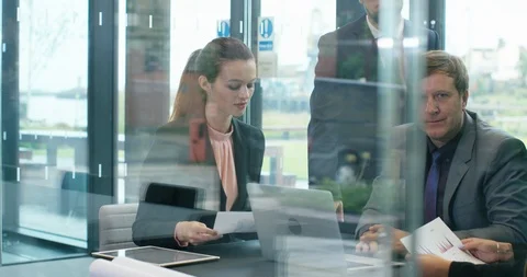 4K Serious business manager looking at camera, surrounded by staff in a meeting Stock Footage 118916391