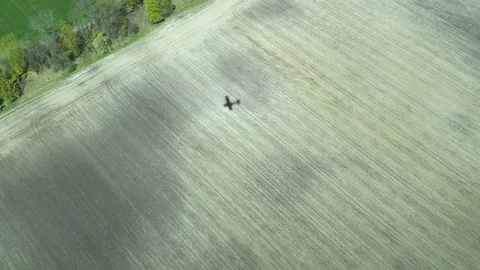 4k Shadow of the plane on a farm field from flying small propeller aircraft Video stock 154997395