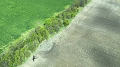 4k Shadow of the plane on a farm field from flying small propeller aircraft Stock Footage 156119068