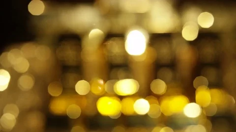4K Shimmering golden particles reflected from out of focus stack of gold bars Stock Footage 72610505
