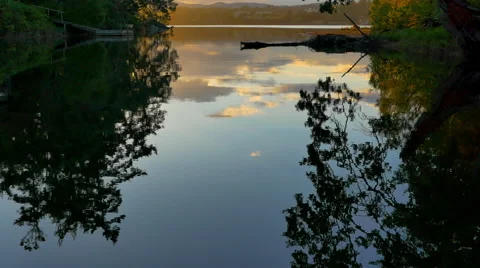4K Shimmering Reflections of Trees and Clouds, Skyline Reflection at Sunset Video stock 68447068