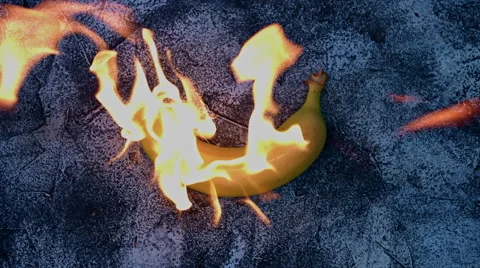 4k shoot of a creative composition with a banana on fire Stock Footage 64263634