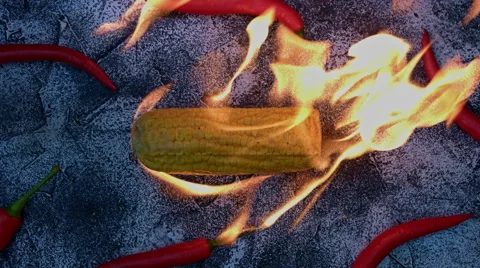 4k shoot of a creative composition with corn and chilli on fire Stock Footage 64266373