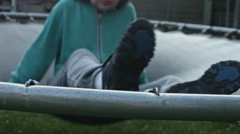 4k shoot of a cute child jumping on a trampoline with rust Stock Footage 64767570