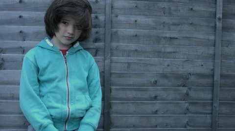 4k shoot of a cute child posing and smiling at camera on a fence background Video stock 63609088