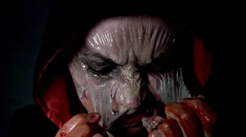 4k shoot of a horror Halloween model taking the skin off face Stock Footage