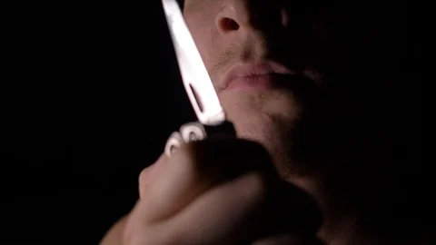 4k shoot of a man in studio licking her knife Stock Footage 94972378