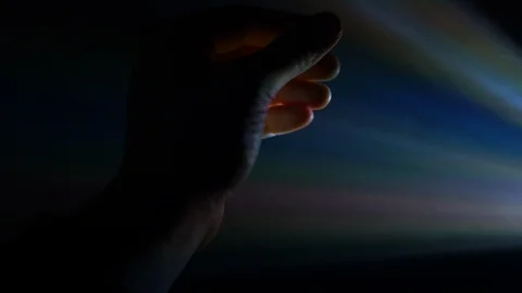 4K Shot Of Beautiful Rays Of Light Shining On Hand Touching Light Covered Stock Footage 122739149