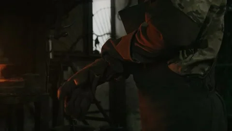 4k shot for a blacksmith man working in front of the furnace Stockbeeldmateriaal 145070423