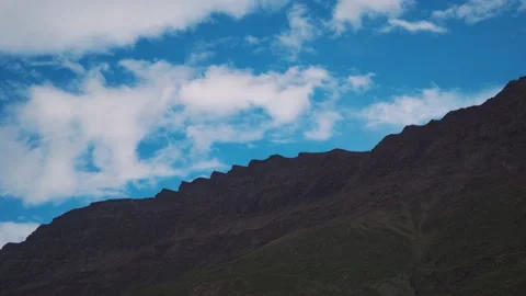4K shot of clouds moving above the mountains as seen from Keylong in Lahaul Stock Footage 220772679