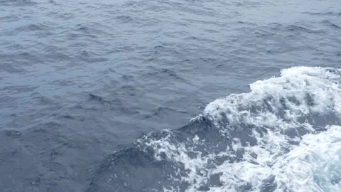 4K shot of deep blue ocean water and white foam wake from a boat 스톡 동영상 337090485