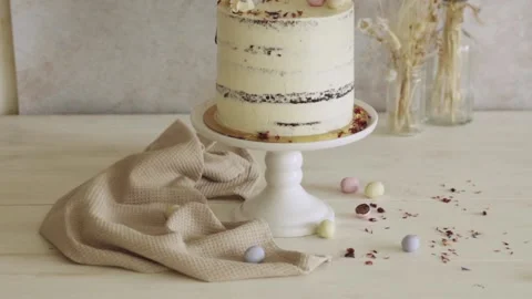 4K shot of a delicious Easter Frohe Ostern Naked Cake on a white decorated table Stock Footage 150789705