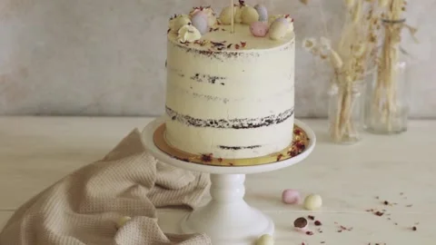 4K shot of a delicious Easter Frohe Ostern Naked Cake on a white decorated table Stock Footage 150789722