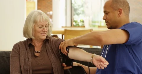 4k, Shot of a doctor checking a senior patient's blood pressure Stock Footage 82879688