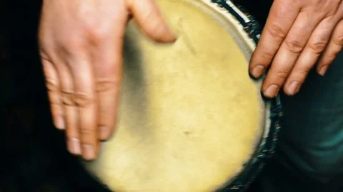 4k shot of a man playing on a Bongo drum close up. Hand tapping a Bongo Video stock 77444359