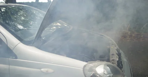 4k, Shot of an overheated car engine with smoke coming out of it. Slow motion. Stock Footage
