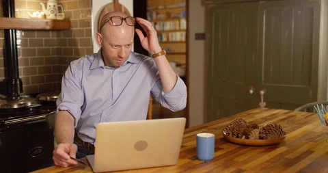 4k Shot of a young man using a credit card to make an online payment at home Stock Footage 128382349
