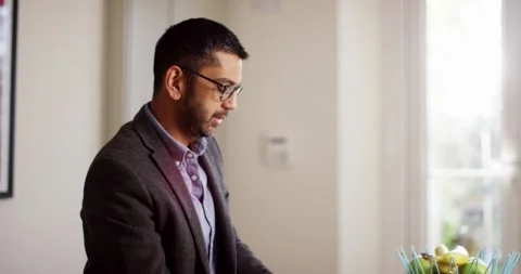 4k  Shot of a young man working from home using smart phone Stock Footage 130631408