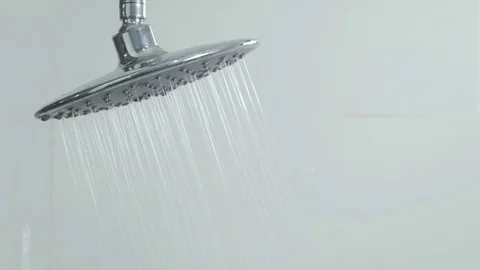4k of Shower head flows water in a bath Stock Footage 76864081