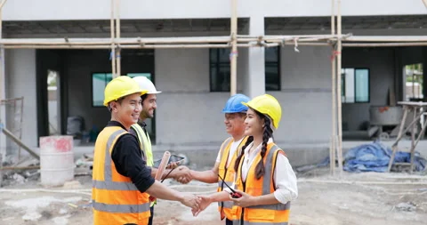 4K side view . Civil engineer shakes hands and then looks around the work site. Stock Footage 194545861