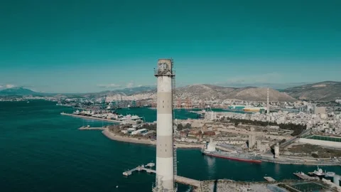 4K Side-View Drone Footage: Abandoned Factory Chimney in Athens with Port of Stockbeeldmateriaal 241893805